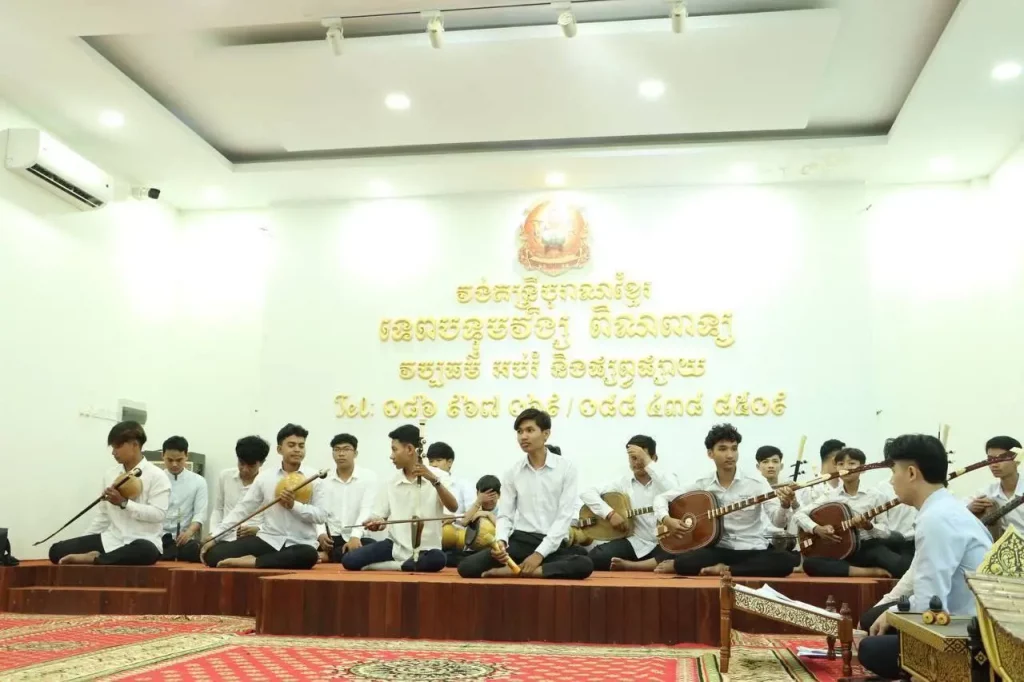 H.E. Hei Virak Brings Donation from the Minister of Culture and Fine Arts to Venerable Pan Chhun, Master of the Pin Peat Orchestra at Wat Botum Vatey Reachevoraram, and Nearly 30 Students Practicing Ancient Pin Peat and Wedding Music
